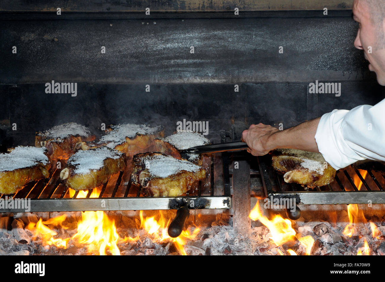 large beef Tbone steak grilled on barbecue grill salted. Sagardi