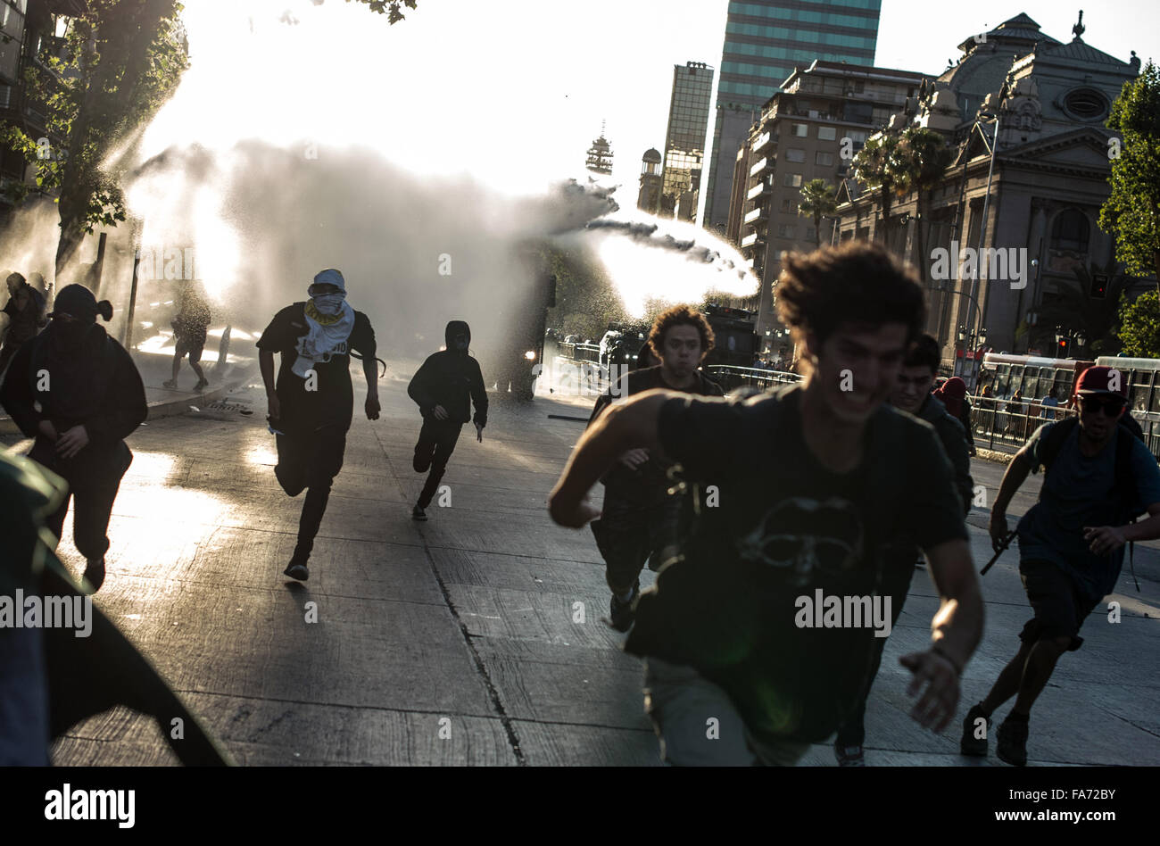 Santiago, Chile. 22nd Dec, 2015. A police vehicle squirts water to demonstrators during a march in demand of free state universities and for the quality of public education in Santiago, Chile, on Dec. 22, 2015. Credit:  Jorge Villegas/Xinhua/Alamy Live News Stock Photo