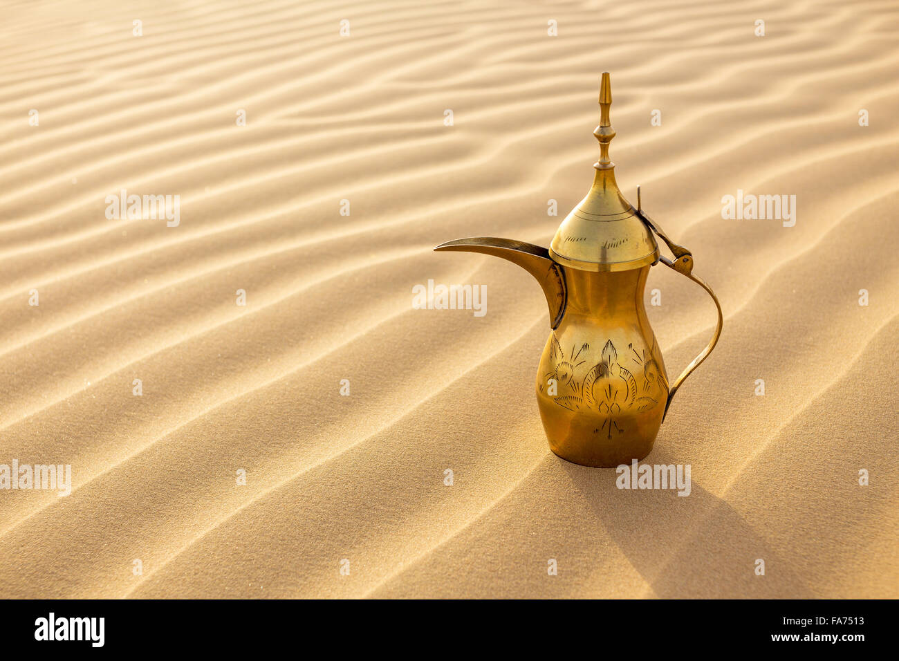 Dalla or Arabic Coffee pot on dessert sanddunes Stock Photo