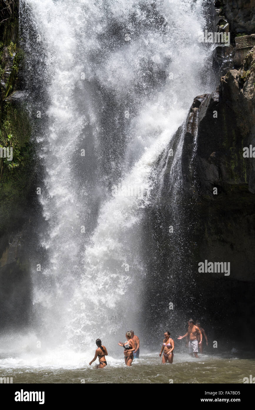 tourists enjoying a bath in the Tegenungan waterfall near Ubud, Bali, Indonesia Stock Photo