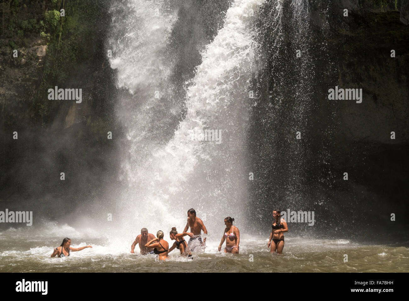 tourists enjoying a bath in the Tegenungan waterfall near Ubud, Bali, Indonesia Stock Photo