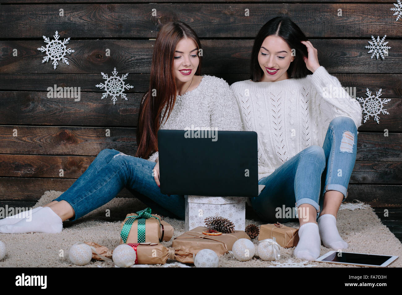 Two beautiful girls siting on the floor Stock Photo - Alamy