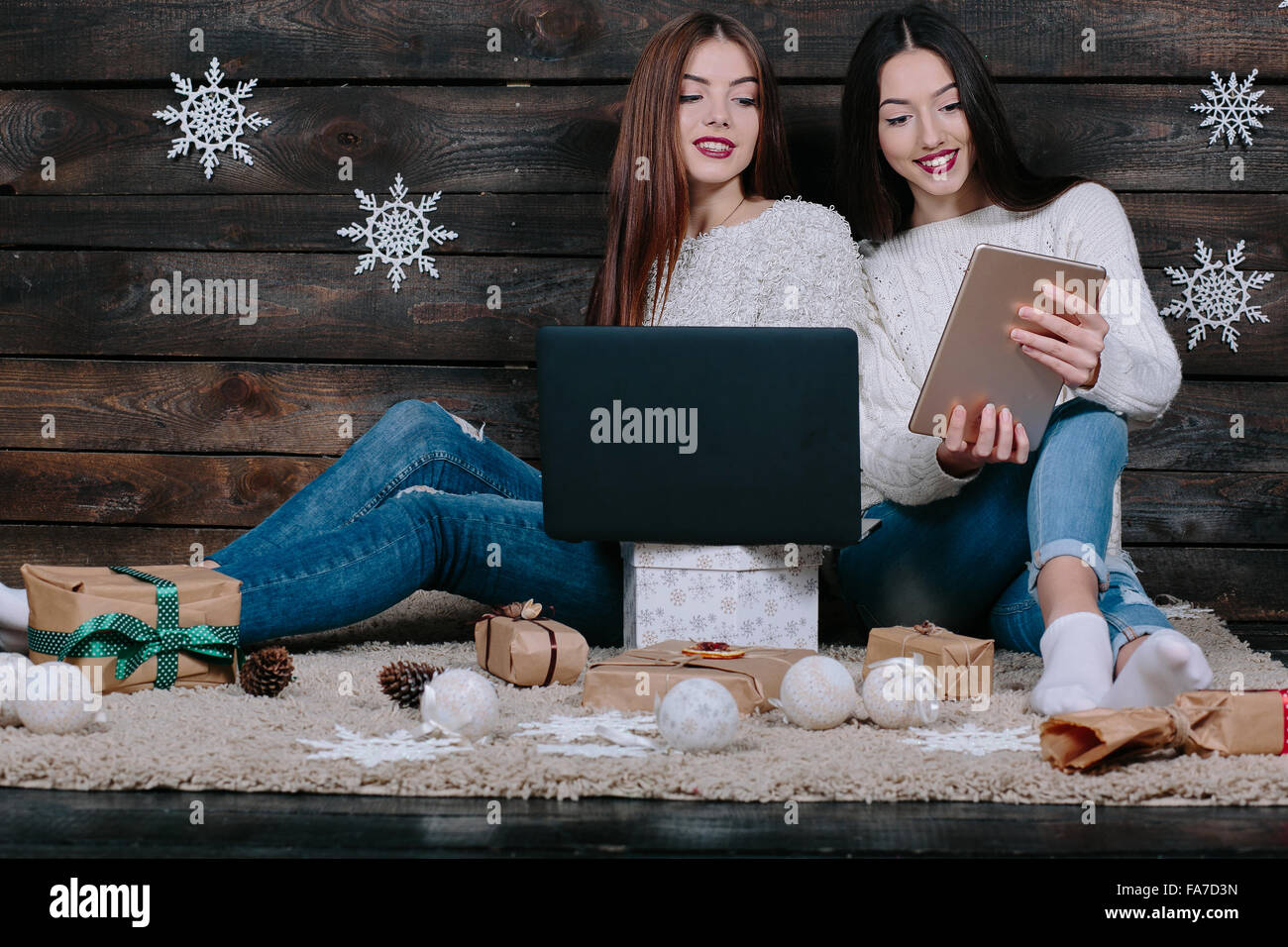 Two beautiful girls siting on the floor Stock Photo - Alamy
