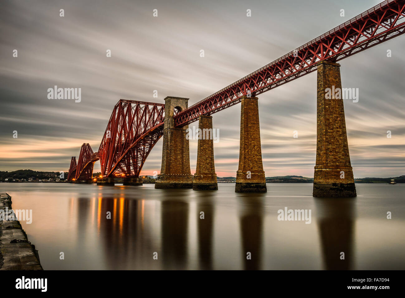 Forth Railway Bridge over the Firth of Forth at sunset in Edinburgh, Scotland, United Kingdom. Long exposure. Stock Photo