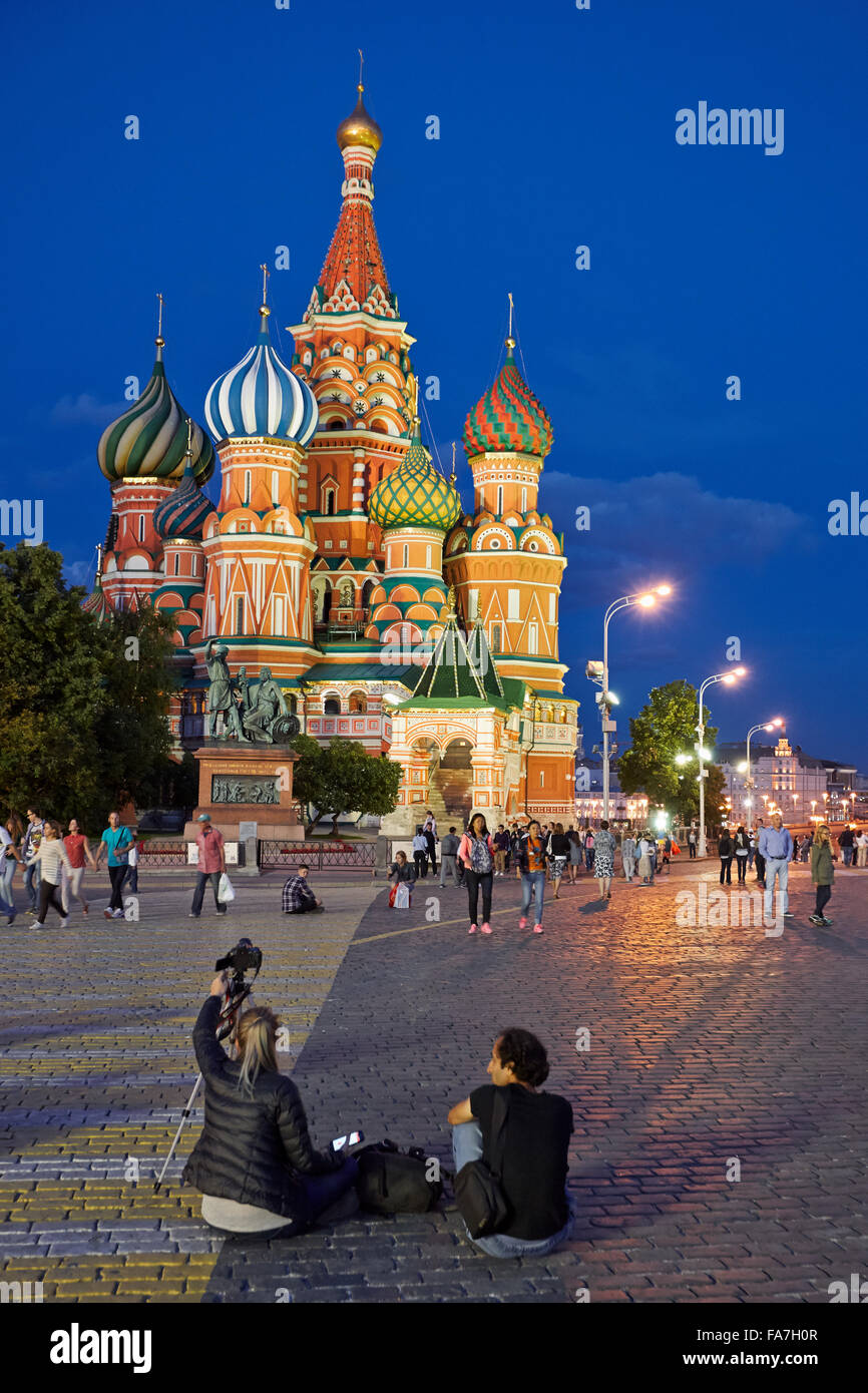 Tourists in the Red Square in front of Saint Basil's Cathedral illuminated at night. Moscow, Russia. Stock Photo