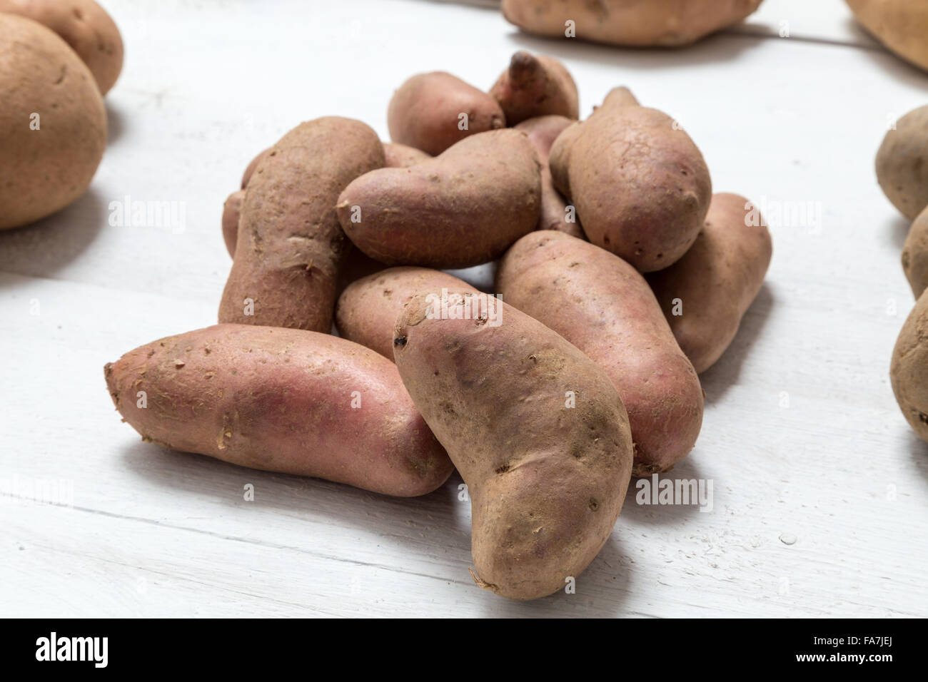 Potatoes on white wooden board Concept. Stock Photo