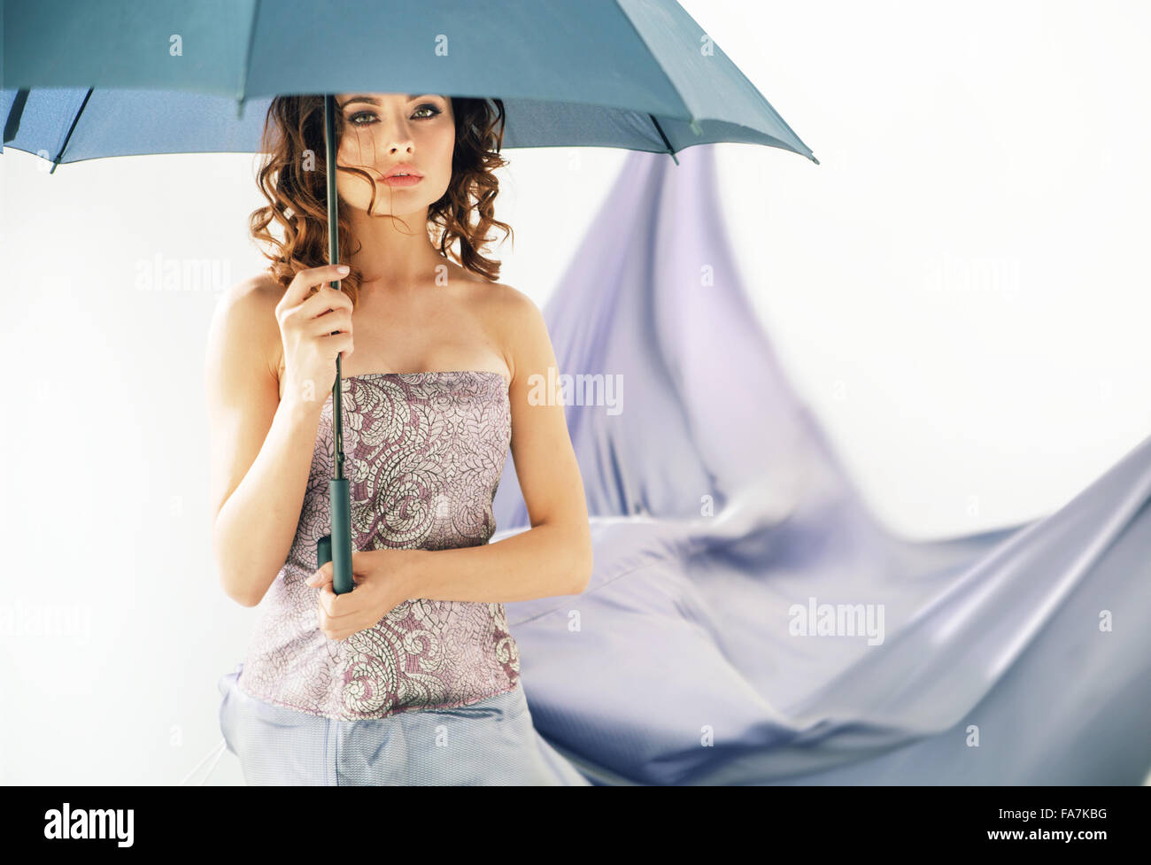 Adorable lady holding an umbrella Stock Photo Alamy