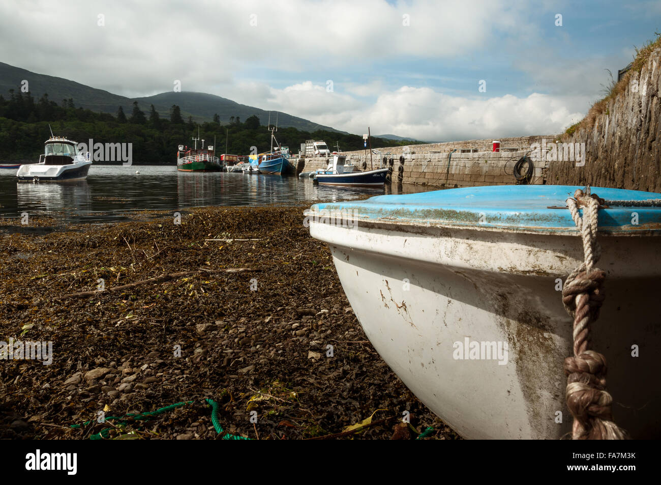 Beached and moored boats at low tide in Kenmare harbour, Kenmare, County Kerry, Ireland Stock Photo