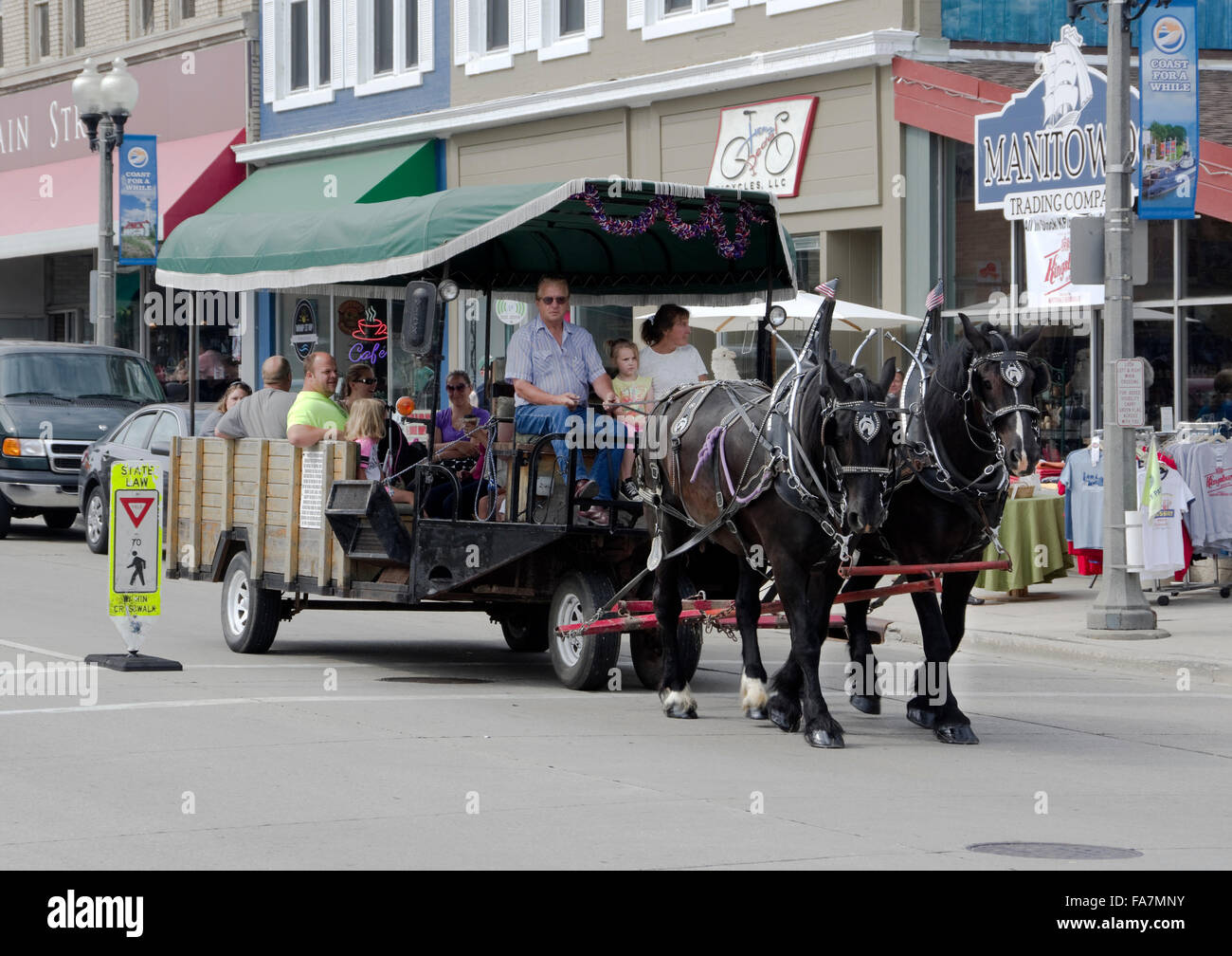 Horse drawn wagon rides during street fair in Manitowoc, Wisconsin