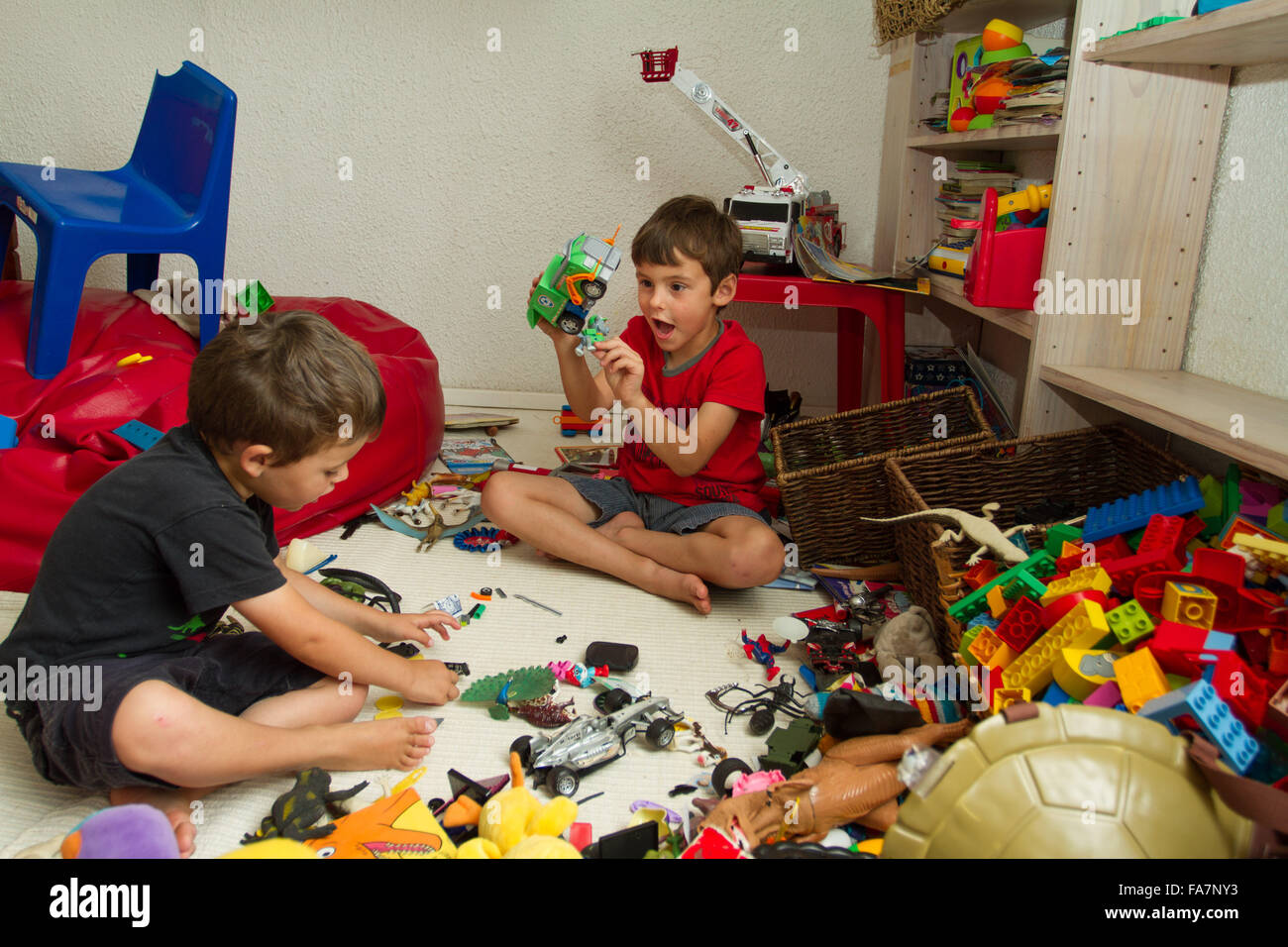 Two toddler brothers playing with toys Stock Photo