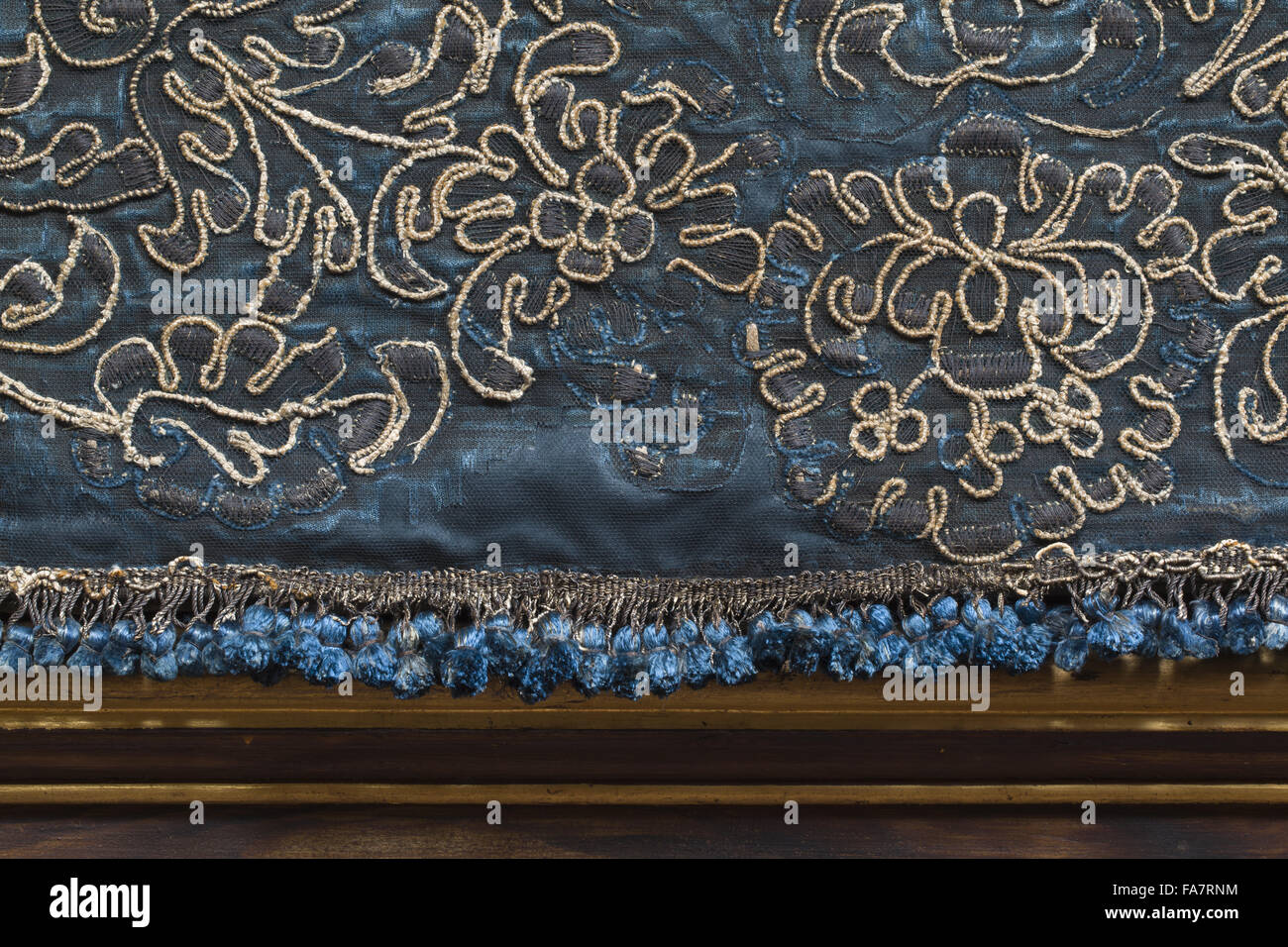 Queen's Antechamber wall hangings at Ham House, Surrey. A close view of the tassels and blue silk velvet borders embroidered with silver gilt threads. Stock Photo