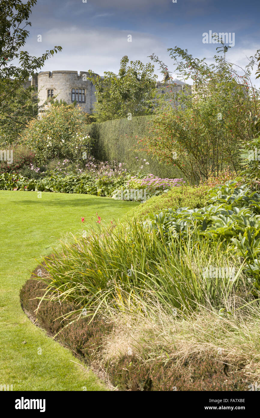 Chirk Castle seen from the Lower Lawn - the border planted with a range of herbaceous perennials and shrubs.  Plants include Japanese anemones, sedum, crocosmias, bergenias, hebes and roses.  Photographed in September Stock Photo