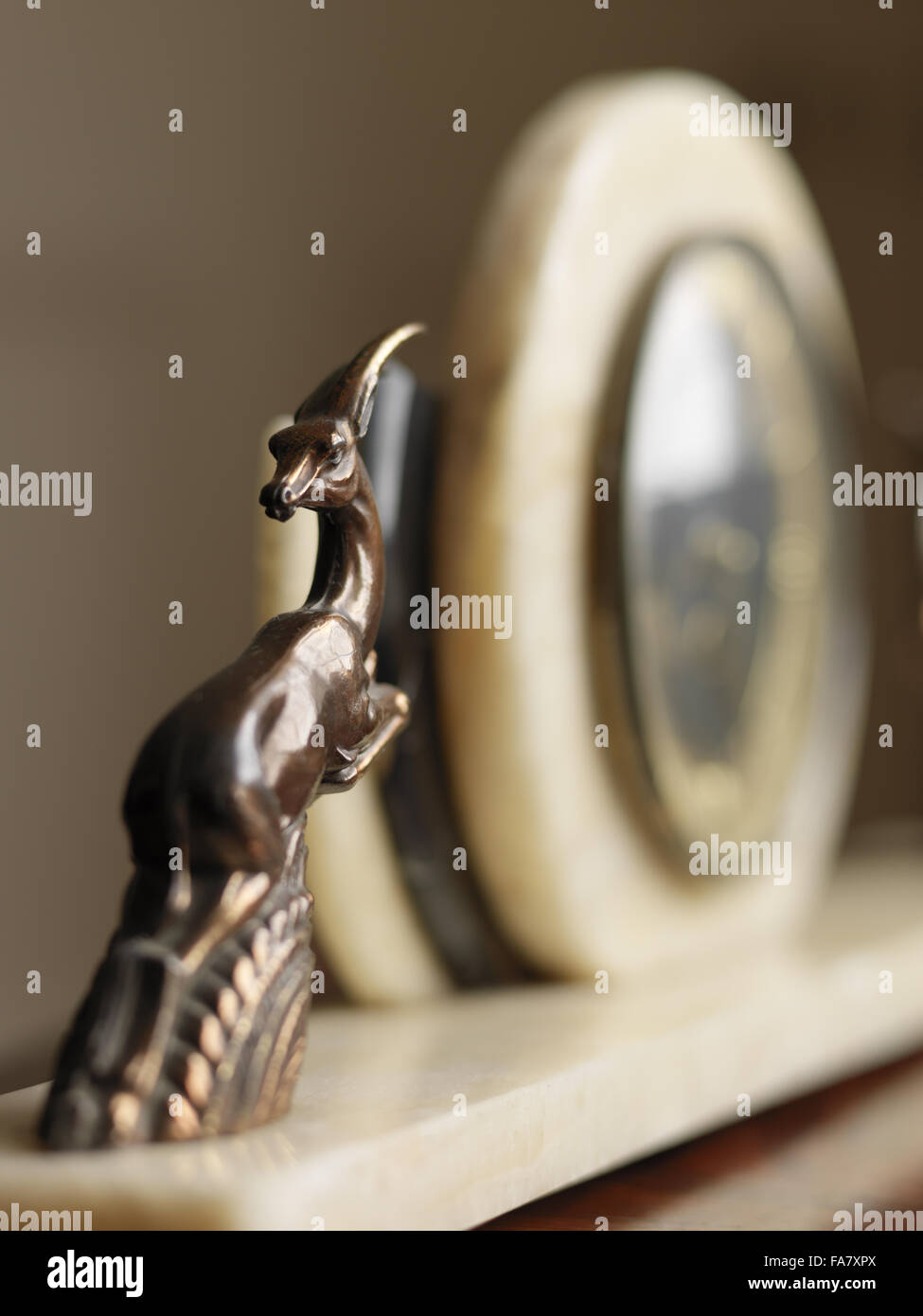 Detail of a 1930s clock, featuring a leaping deer-like creature, Portland House, Dorset. The house was built in 1935 for Geoffrey Bushby and is now available for hire as National Trust holiday accommodation. Stock Photo