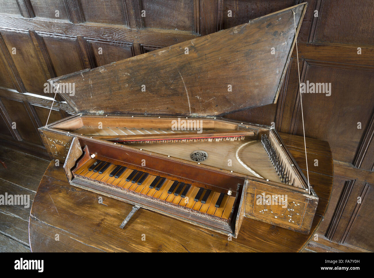 A 16th century virginal showing a detail of the inscription (and date of 1537) over the keyboard, in the Music Room at Westwood Manor, Wiltshire. Stock Photo