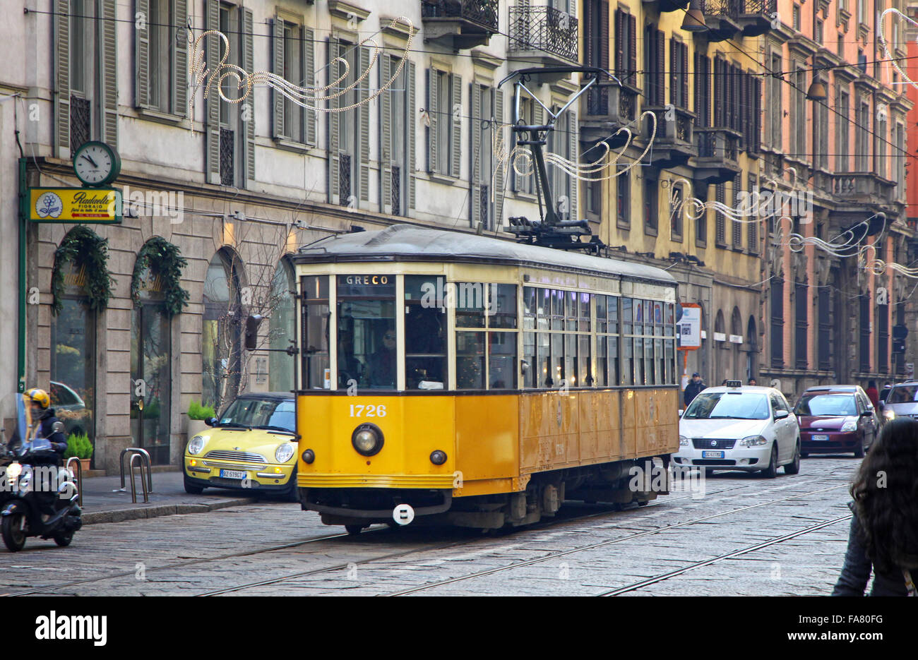 MILAN, ITALY - DECEMBER 31, 2010: Old traditional tram (ATM Class 1500) on the street of Milan. Milan tramway network operation Stock Photo