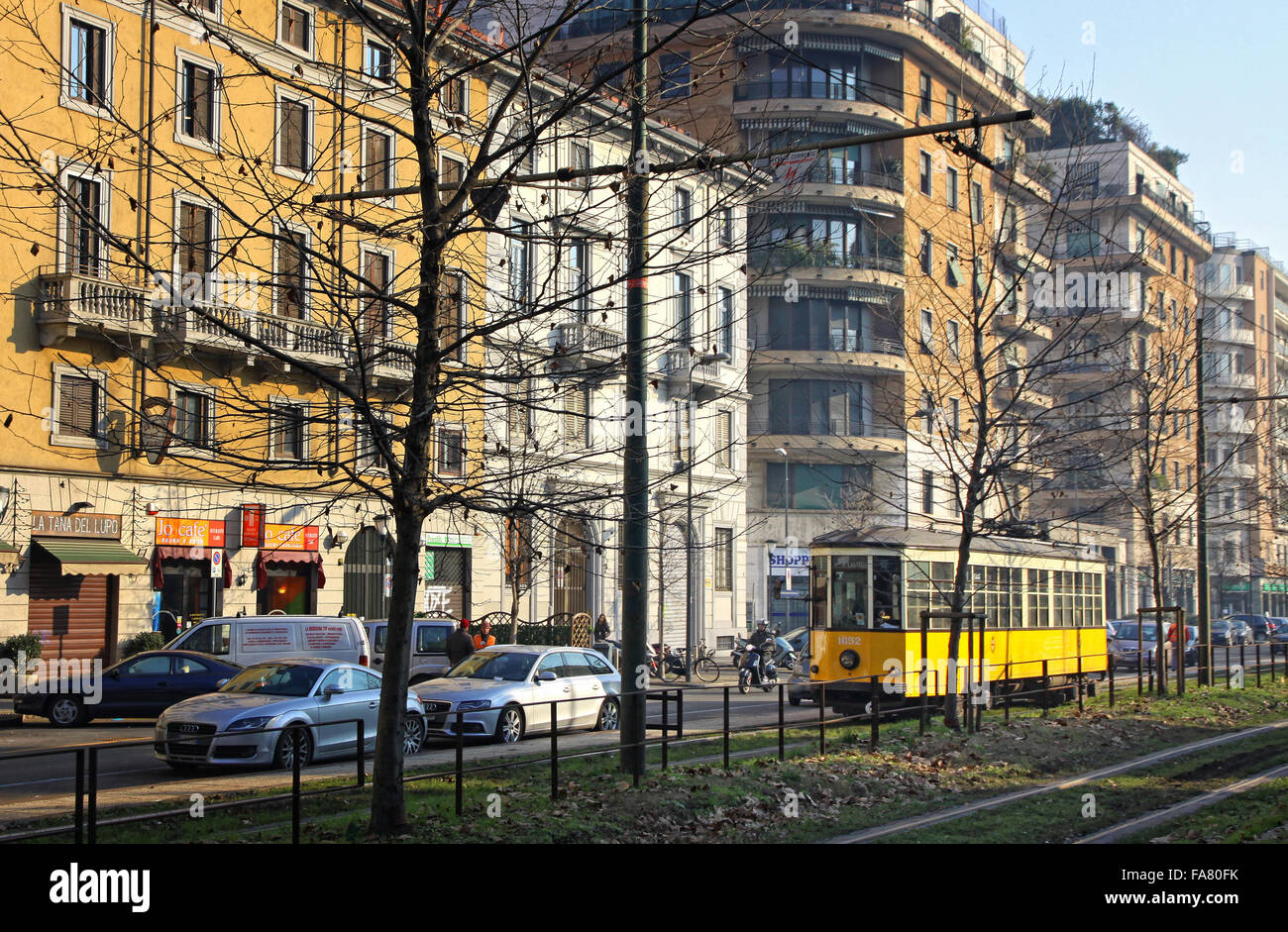 MILAN, ITALY - DECEMBER 31, 2010: Old traditional tram (ATM Class 1500) on the street of Milan. Milan tramway network operation Stock Photo