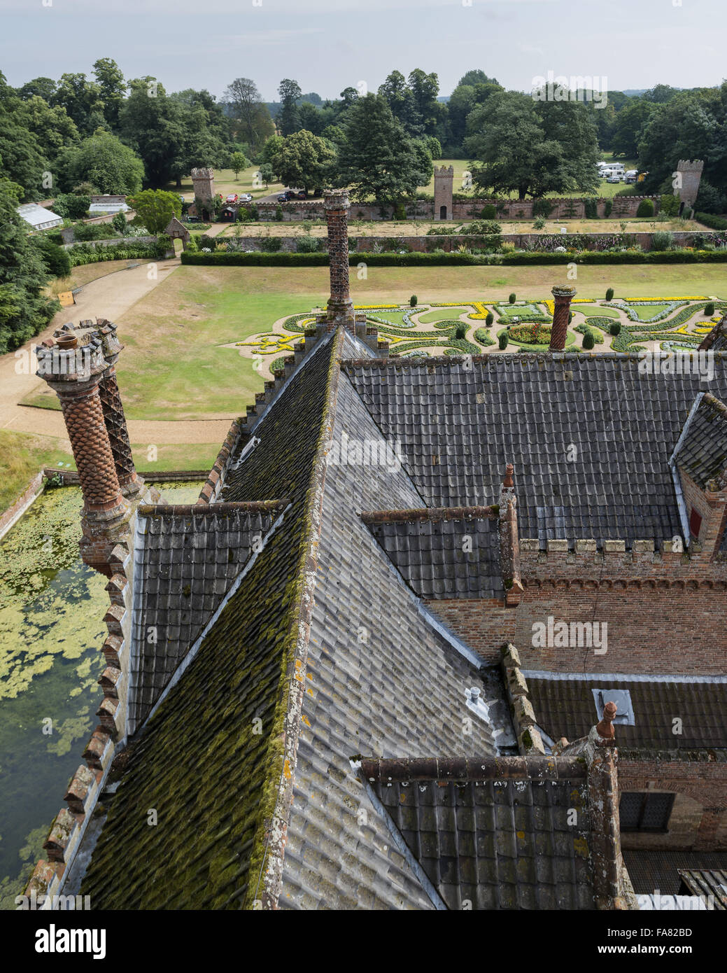 View of the rooftops, moat and gardens of Oxburgh Hall, Norfolk, from the Gatehouse Tower. Stock Photo