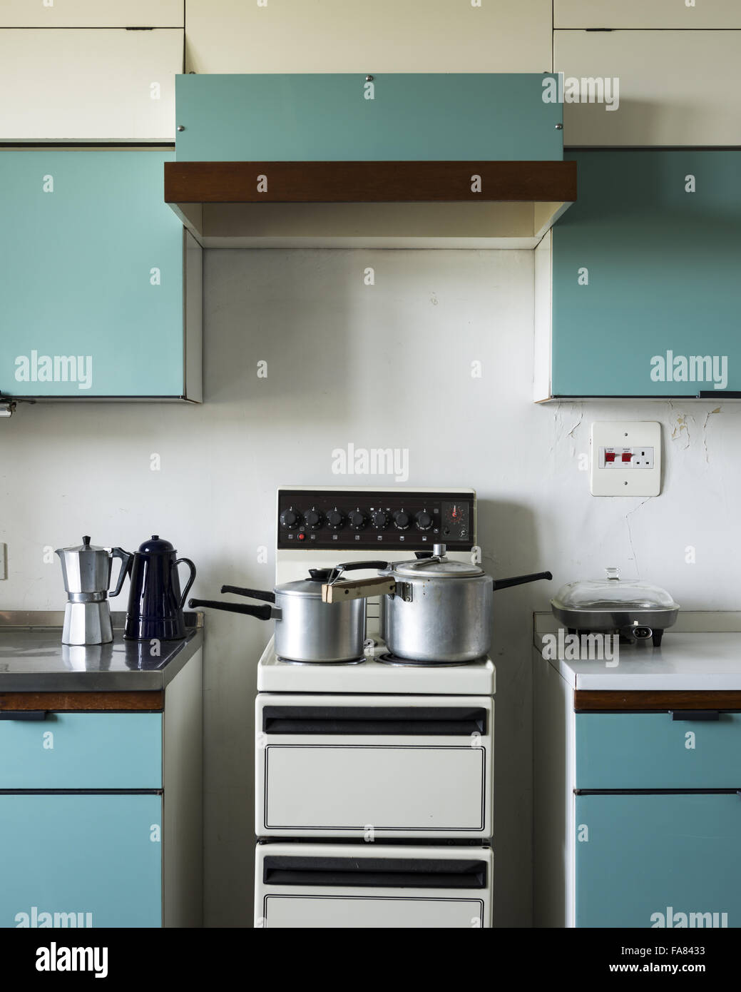 The Blue Kitchen at Dunster Castle, Somerset, with electric cooker and blue 1950s kitchen units installed by the sons of Alys Luttrell. Stock Photo