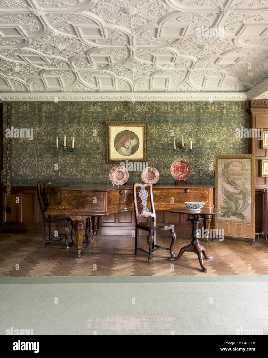 An interior view of Wightwick Manor and Gardens, West Midlands. Wightwick Manor was begun in 1887 in the 'Old English' style, and has a superb collection of William Morris fabrics and Pre-Raphaelite paintings. Stock Photo