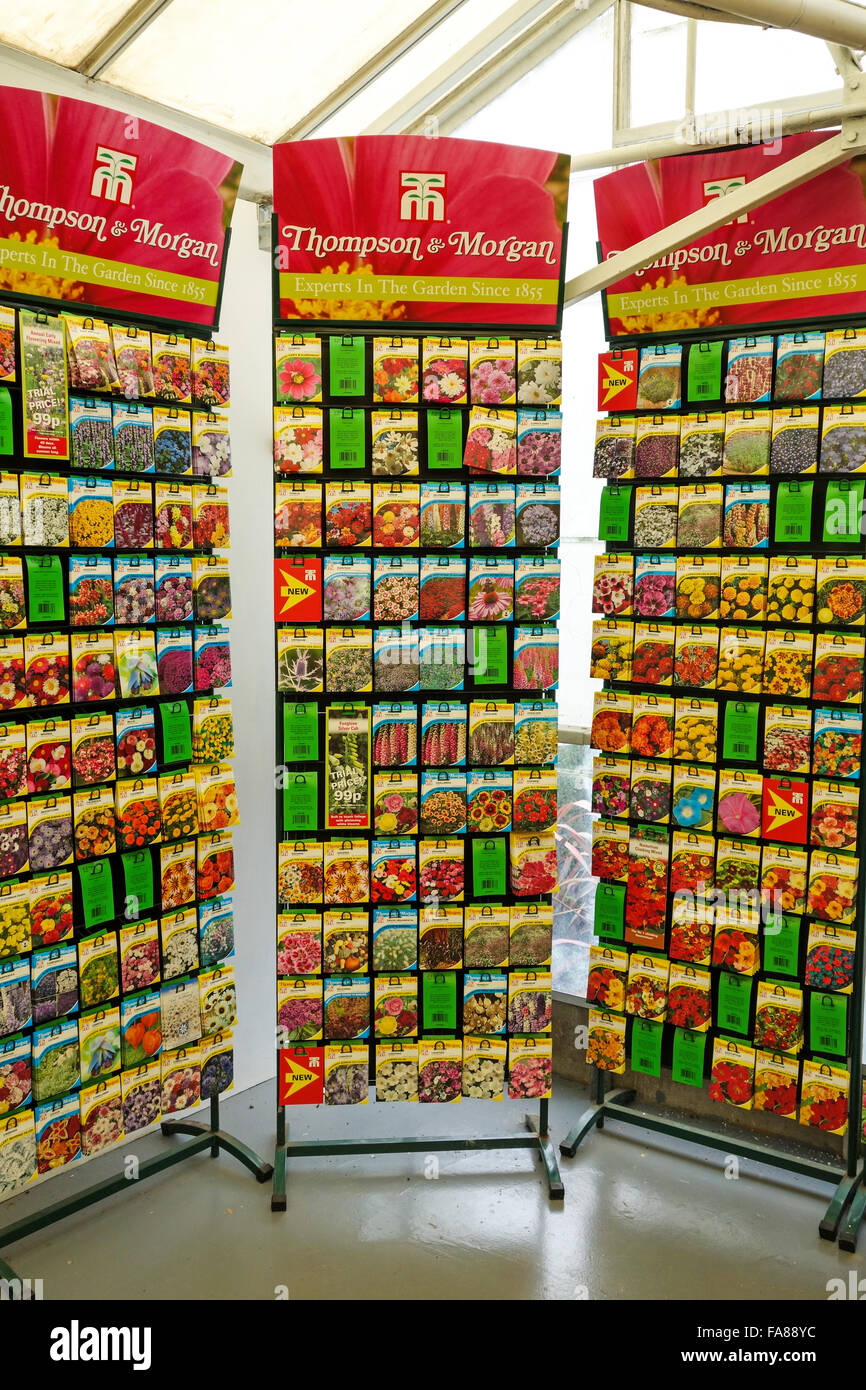 Packets of Thompson and Morgan flower seeds for sale on a display stand in a garden centre Stock Photo