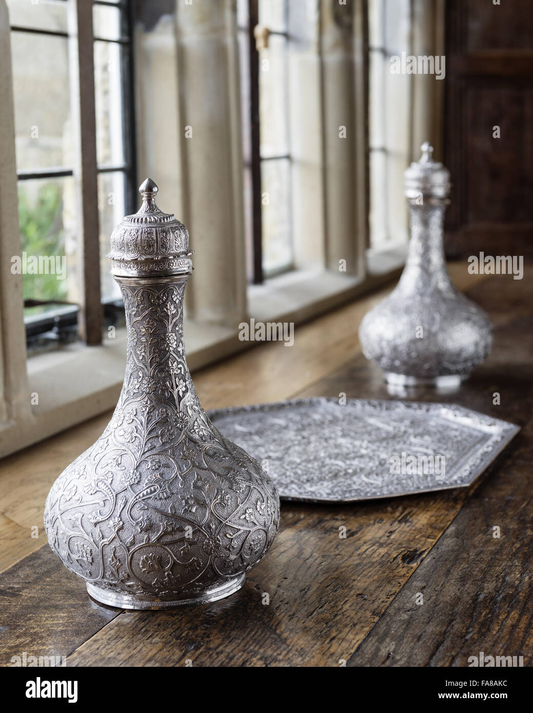 Silver bottles and a tray on a window sill in the Dining Room at Bateman's, East Sussex. Bateman's was the home of the writer Rudyard Kipling from 1902 to 1936. National Trust Inventory Numbers 761501.1 and 761501.2 and 761502. Stock Photo