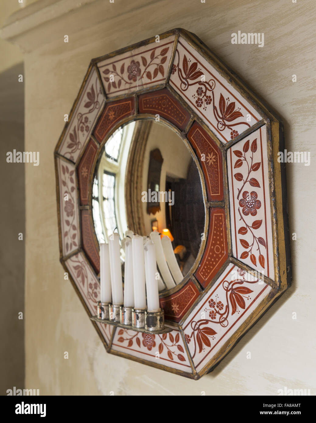 A Florentine mirror, hanging on a wall at Nymans, West Sussex. Stock Photo