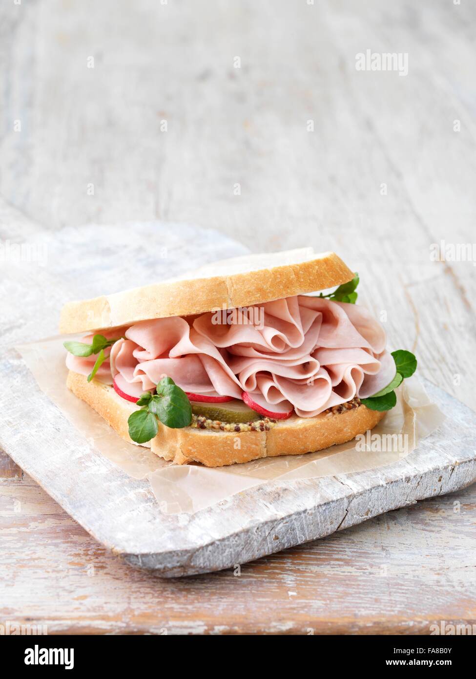 Wafer thin ham, wholegrain mustard, sliced gherkins and radish sandwich