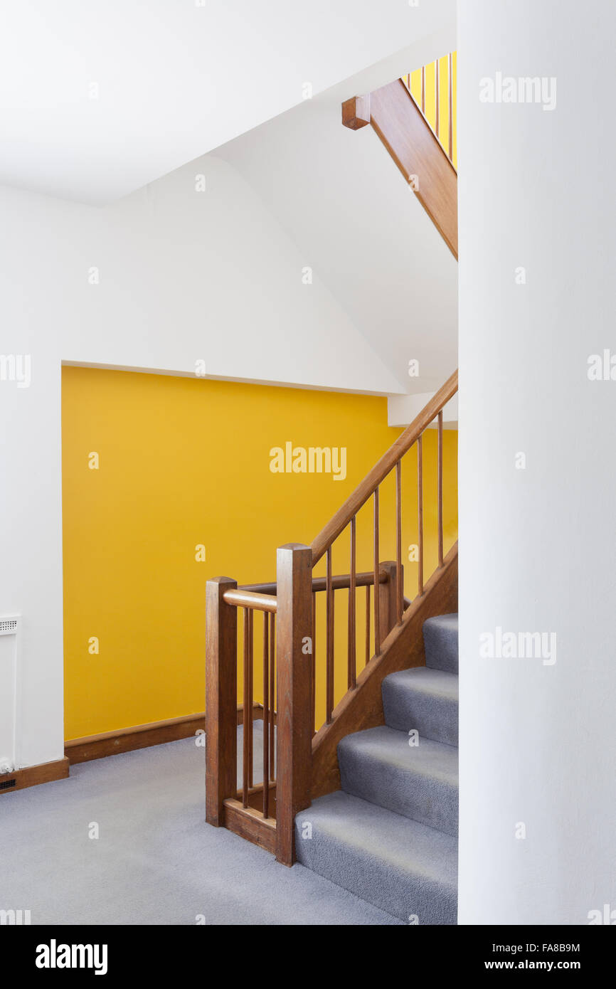 Tower house accessed by luminous staircase