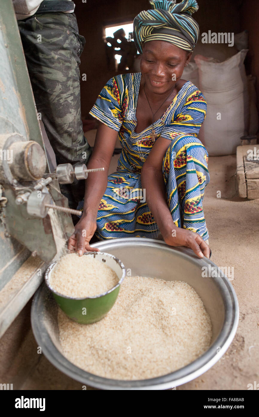 Rice is milled before being sold at a women's group processing center in Sourou Province, Burkina Faso. Stock Photo