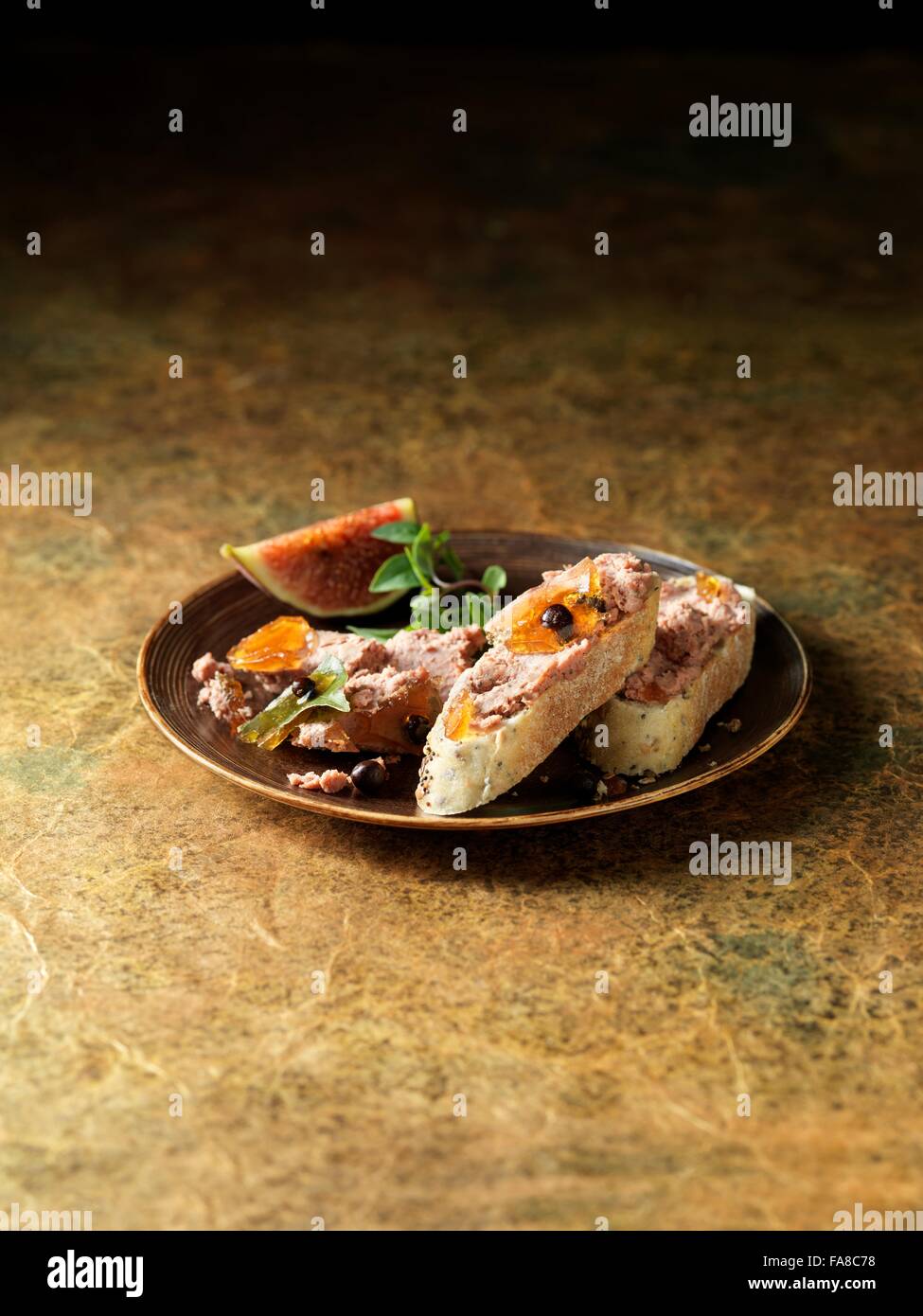 Plate of venison pate with irish whisky on bread with figs Stock Photo