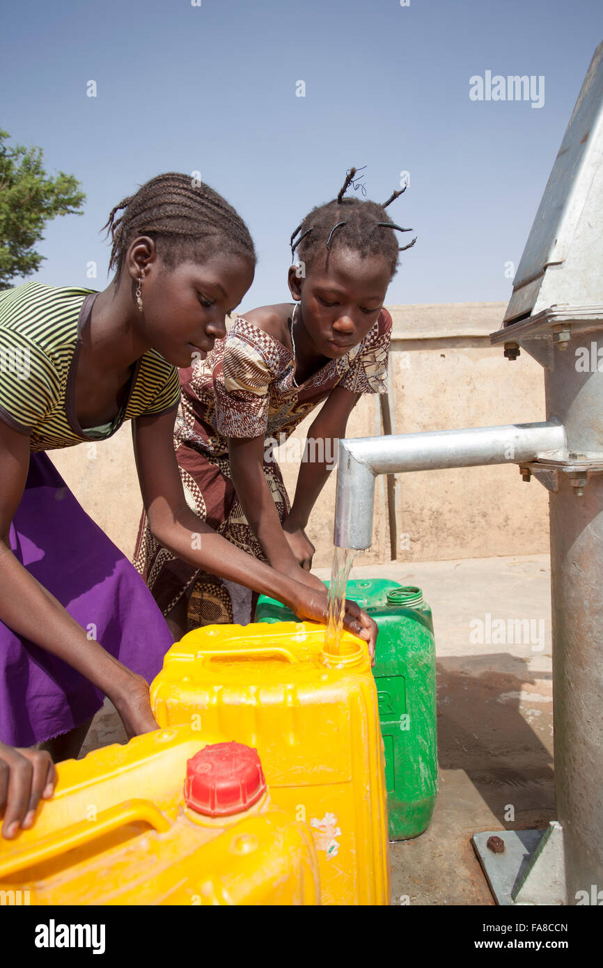 Girls get fresh water from a well in Kouka Department, Burkina Faso, W. Africa. Stock Photo