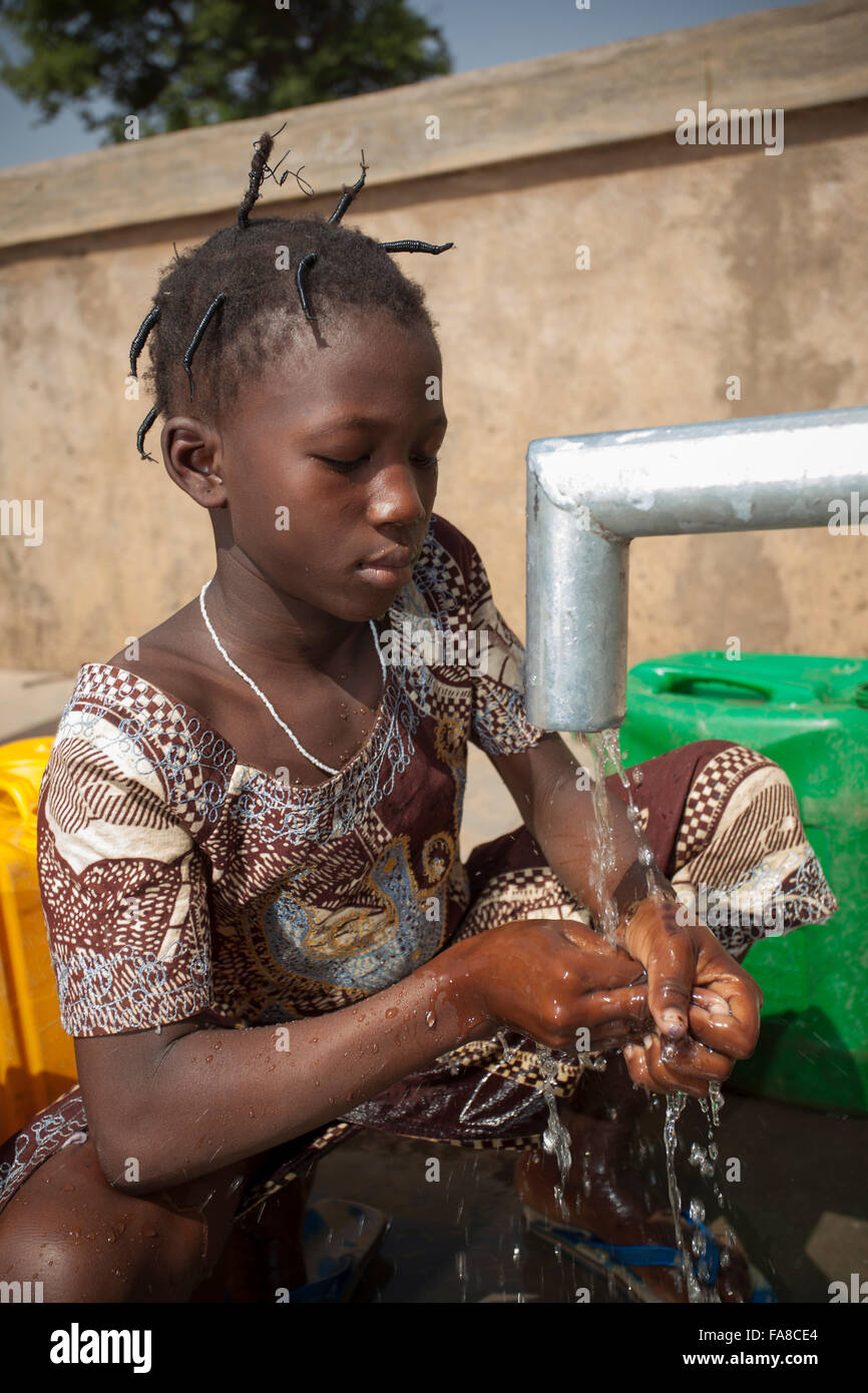 Girls get fresh water from a well in Kouka Department, Burkina Faso, W. Africa. Stock Photo