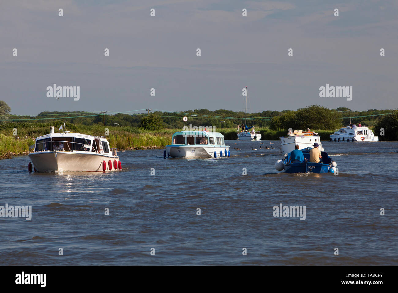 Boating traffic on the Norfolk Broads' busy River Yare Stock Photo