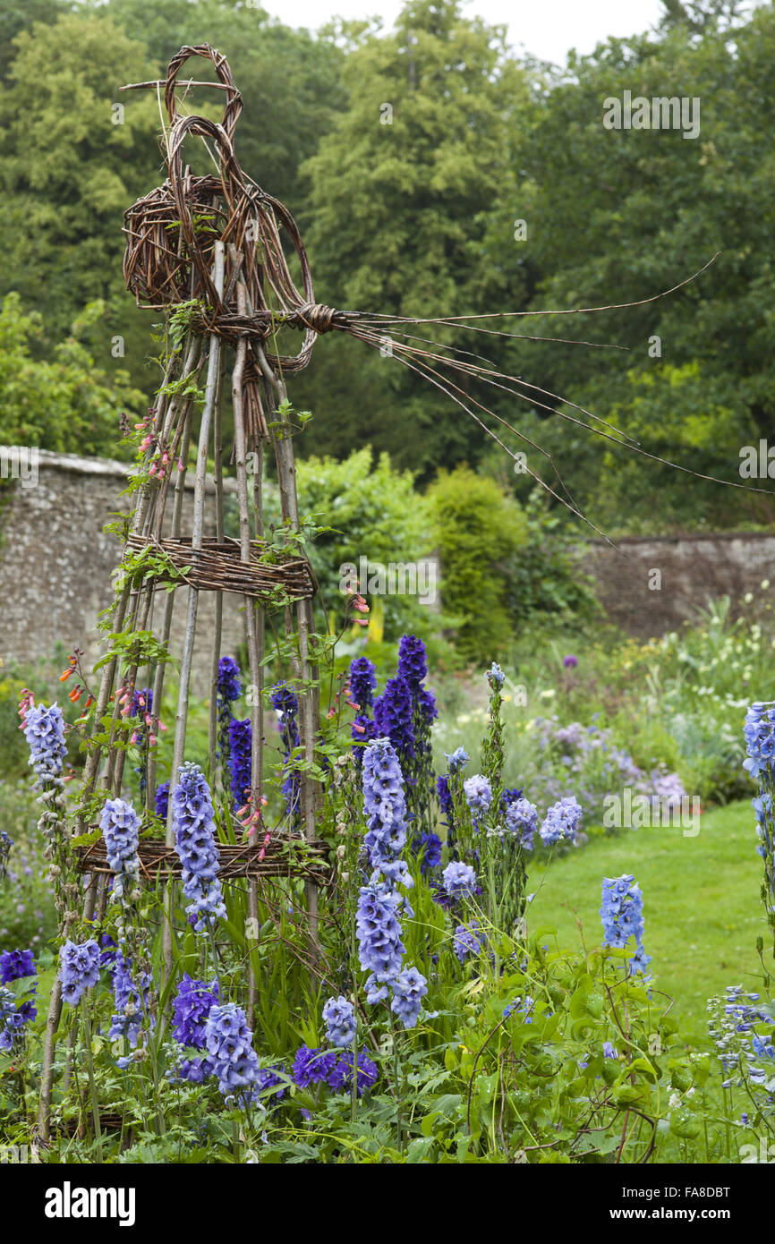 Willow plant support with Delphiniums in the Botanic Garden at Lacock Abbey, Wiltshire, in June. Stock Photo