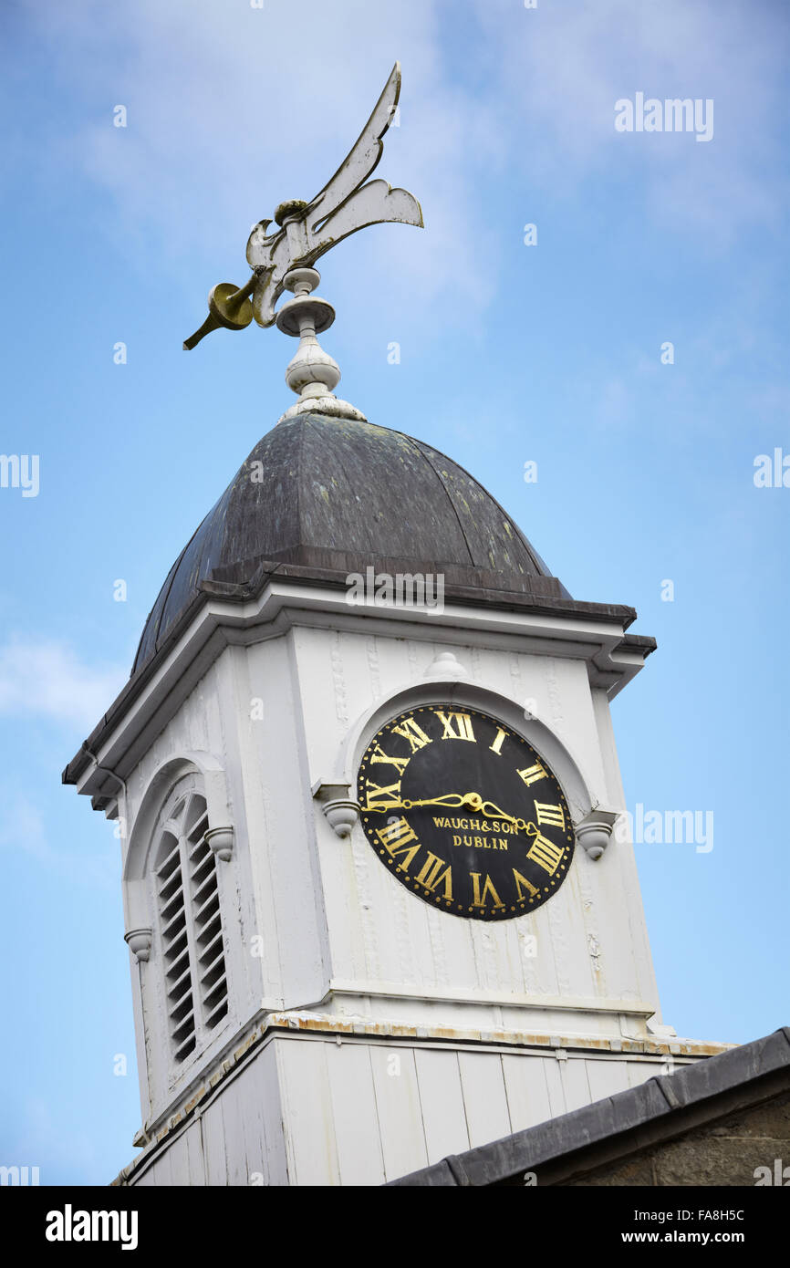 Clock tower with weathervane on the stable block at The Argory, County Armagh. The clock is an eight-day striking turret clock by Waugh and Son of Dublin. Stock Photo