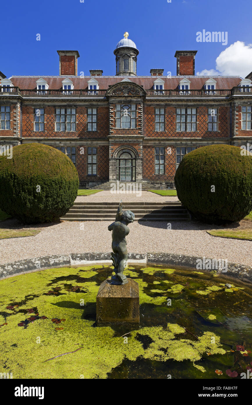 The south front of Sudbury Hall, Derbyshire, with an ornamental pond and fountain in the foreground. Stock Photo