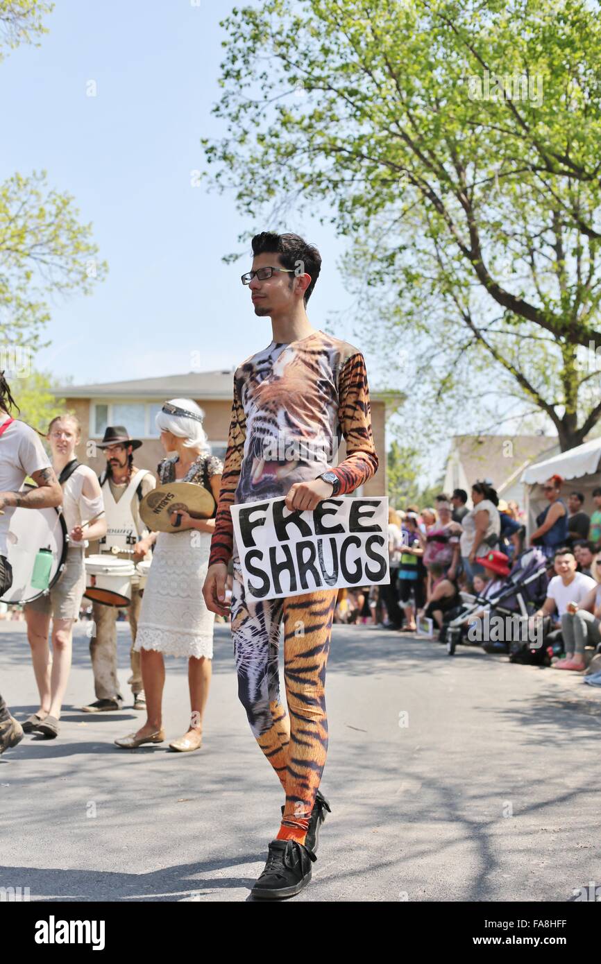 A man carrying a sign reading 'free shrugs' at the May Day parade in Minneapolis. Stock Photo