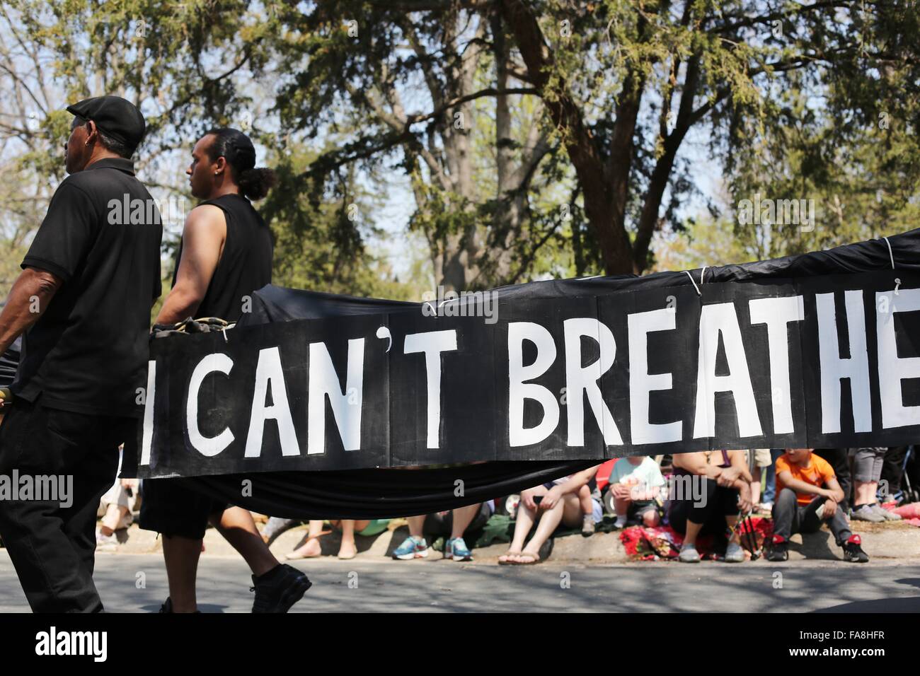 African American people protesting death of black men by police, carrying a banner reading "I can't breathe" in Minneapolis. Stock Photo