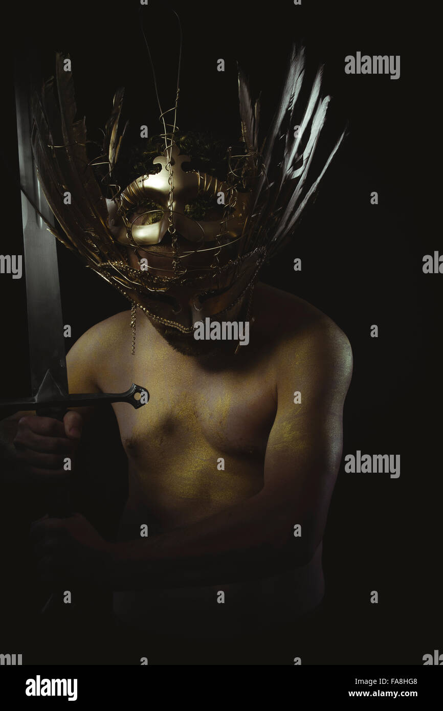 vintage warrior helmet and gold feathers, giant iron sword Stock Photo