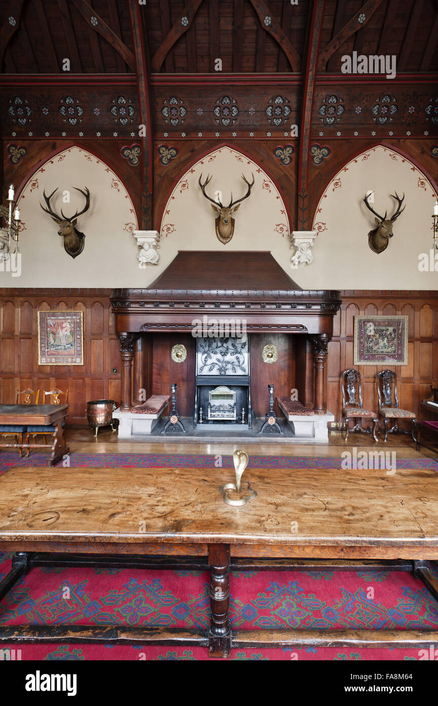 View towards the teak chimneypiece in the Great Hall at Knightshayes Court, Devon. Stock Photo