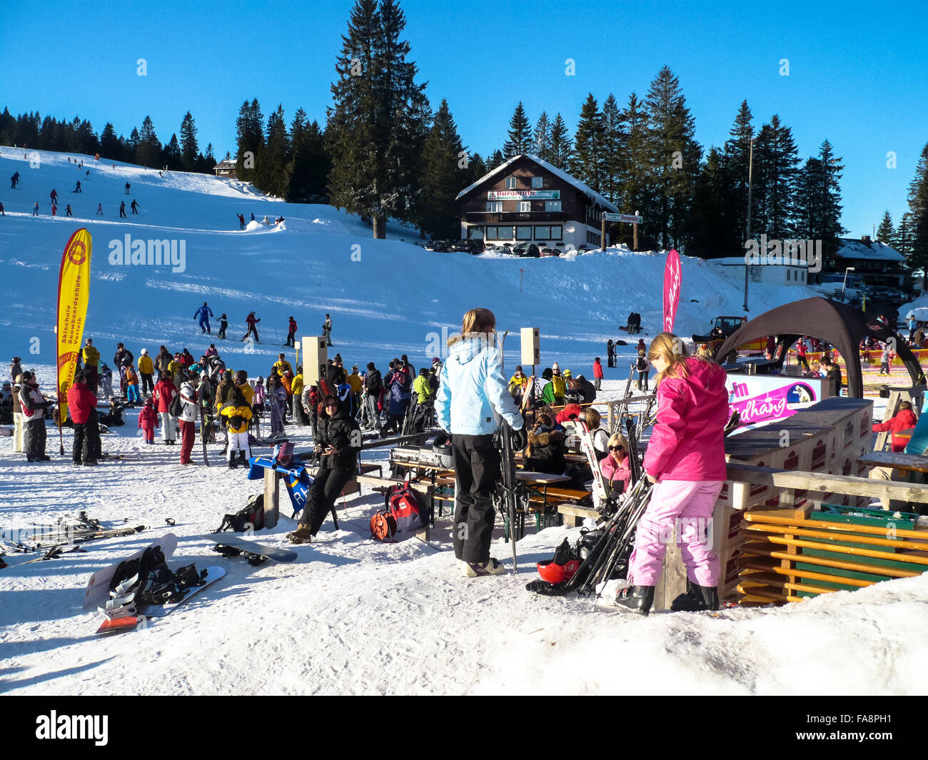 youngsters at restaurant in winter landscape and ski area of feldberg germany Stock Photo