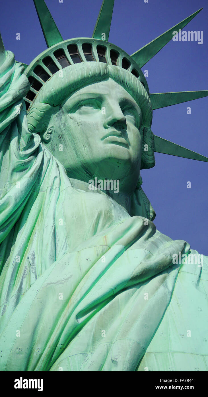 Statue of Liberty under a blue sky in New York Harbor Stock Photo Alamy