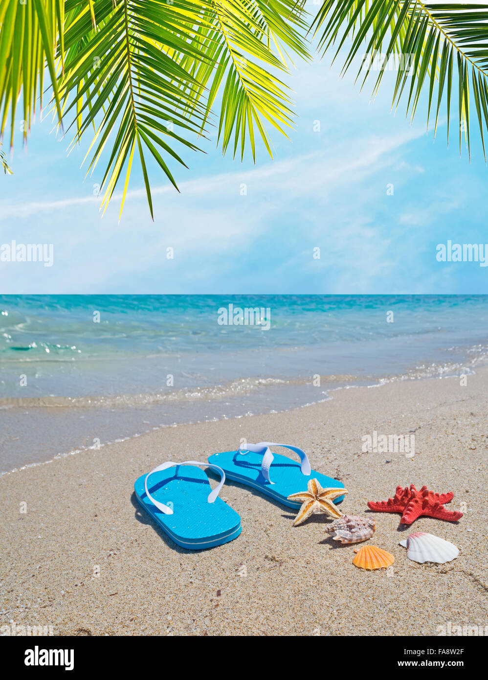 flip flops on the sand in a tropical beach Stock Photo - Alamy