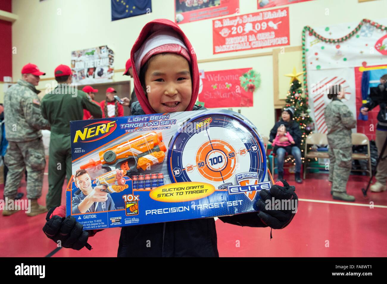 A young Native Alaskan boy smiles after receiving presents from volunteers during Operation Santa Claus December 5, 2015 in St. Mary's, Alaska. The program has been held for 59 years and brings Christmas cheer to underserved, remote villages across Alaska. Stock Photo