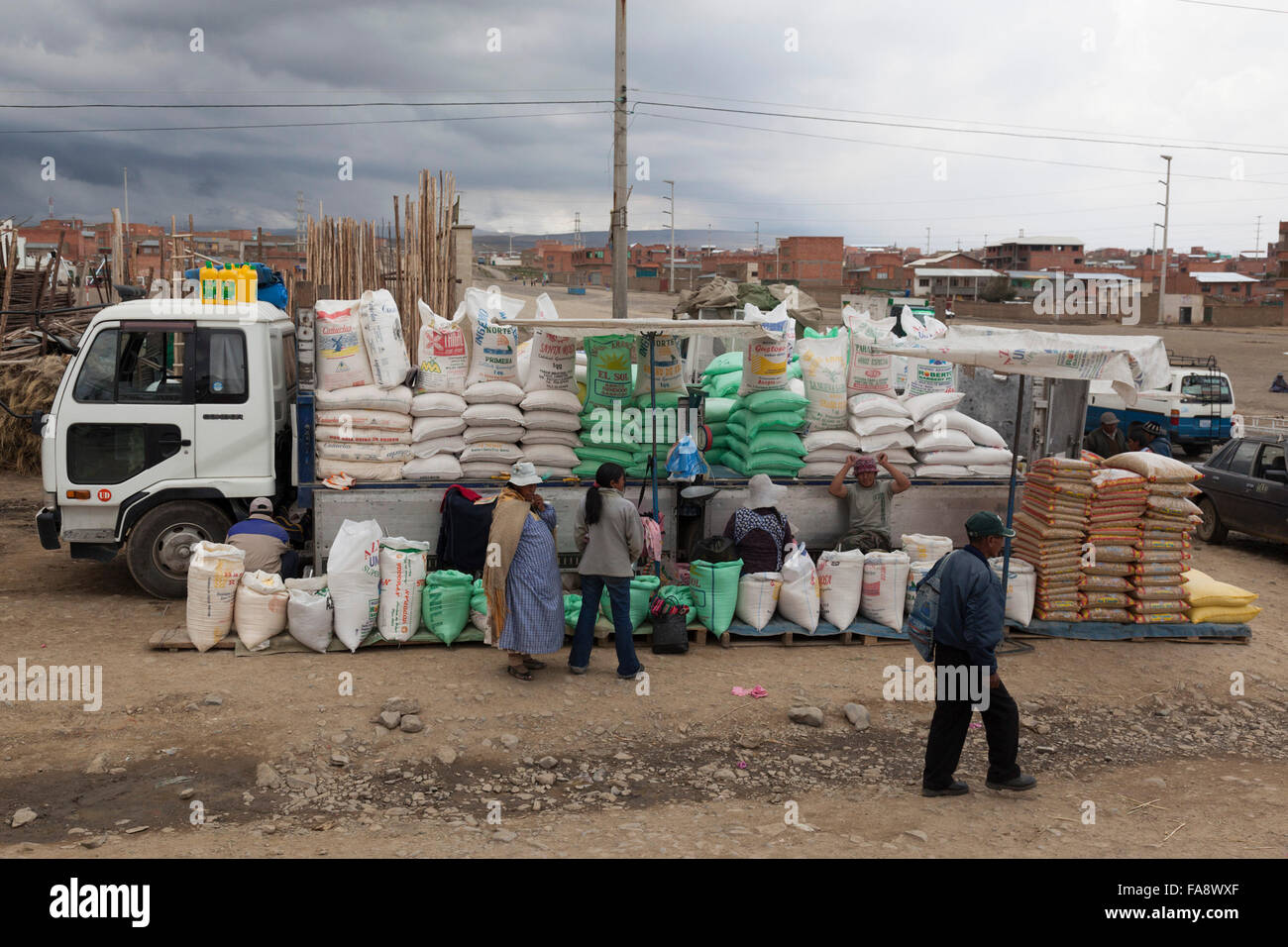 Rice and grains are being sold from a lorry in an urban settlement near ...