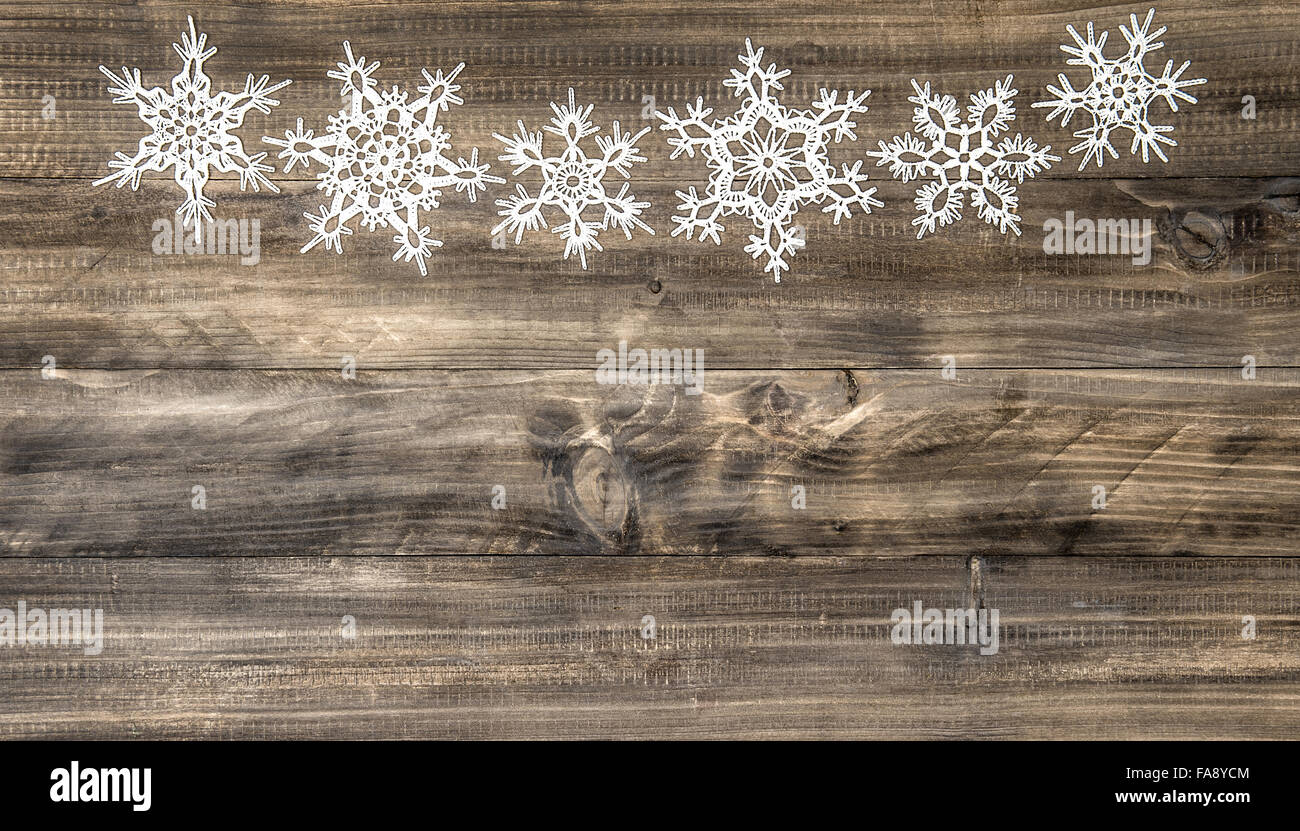 Christmas ornament white snowflakes on rustic wooden background Stock Photo