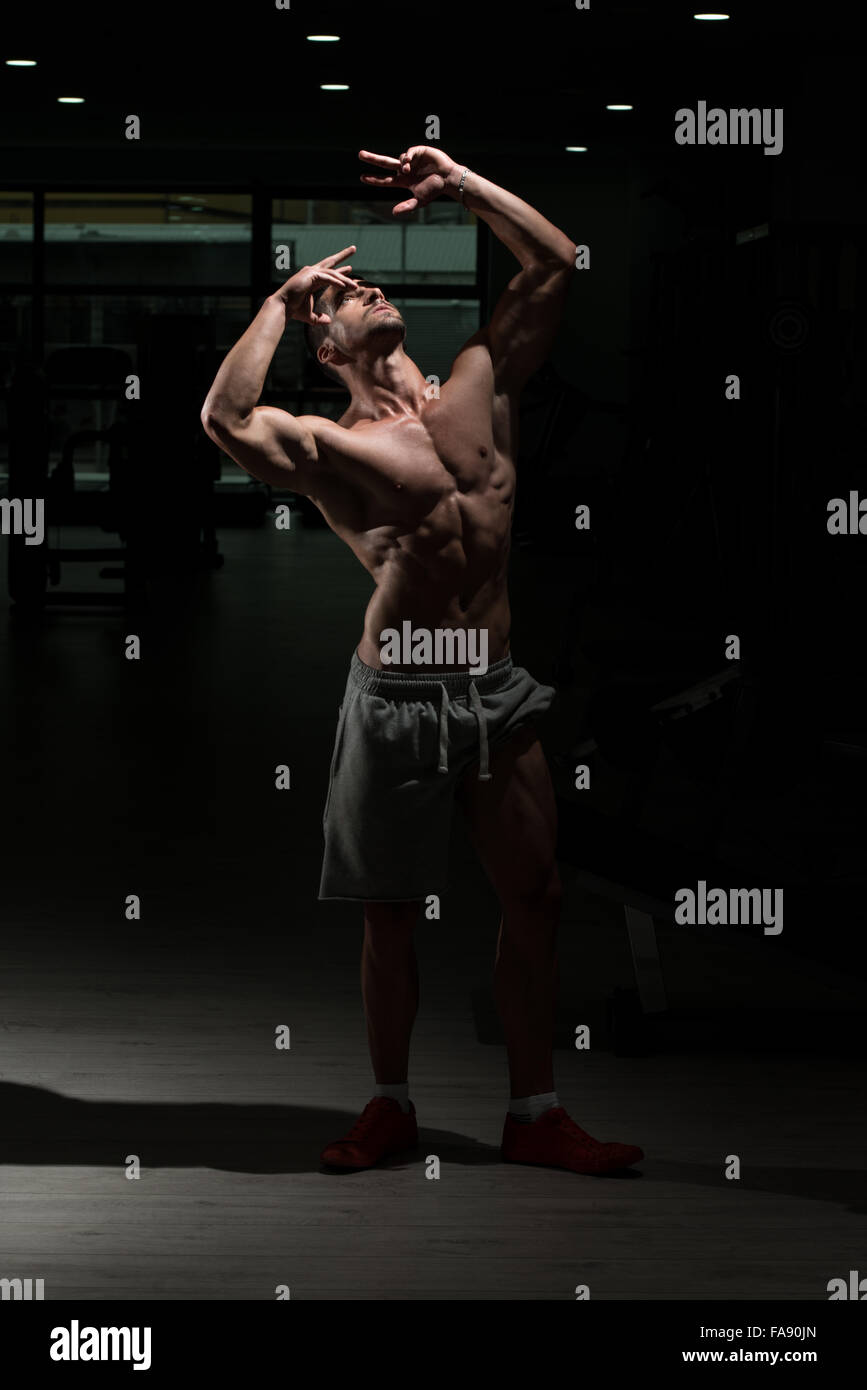 Athlete Muscular Brutal Bodybuilder Emotional Posing In A Dark Gym ...