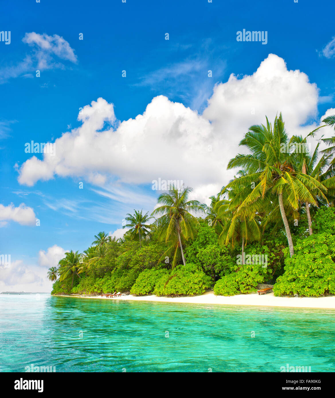 Tropical island beach. Palm trees. Turquoise water. Blue sky Stock Photo
