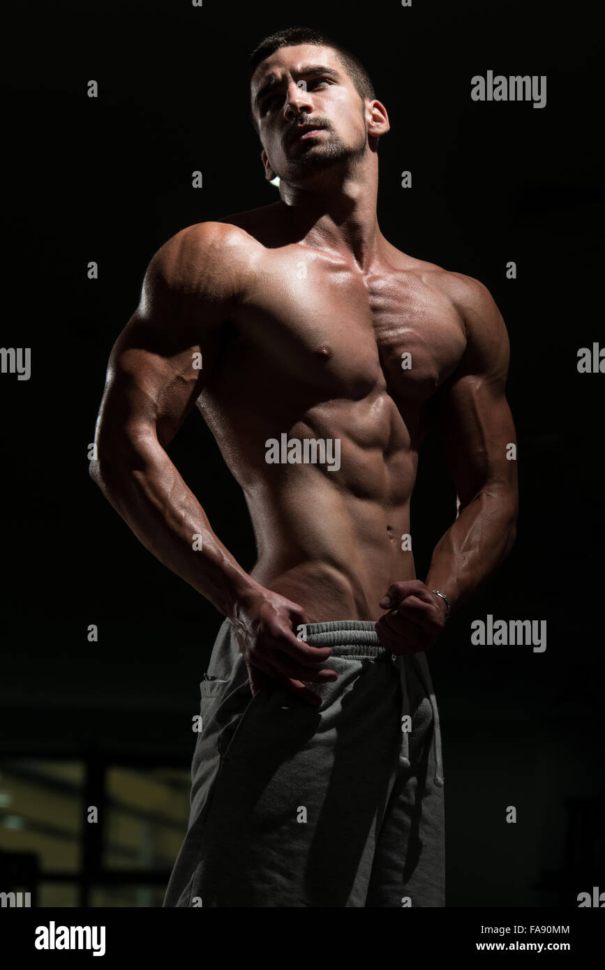 Agressive Bodybuilder Athlete Muscular Brutal Bodybuilder Emotional Posing In A Dark Gym ...