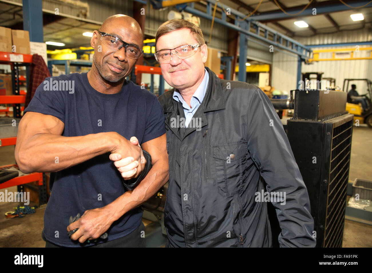 Black and white engineers meeting in a hires stock